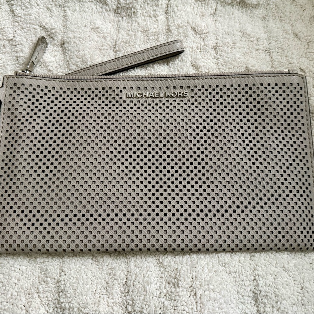 Michael Kors Jet Set Large Zip Clutch Wristlet in a gray perforated leather